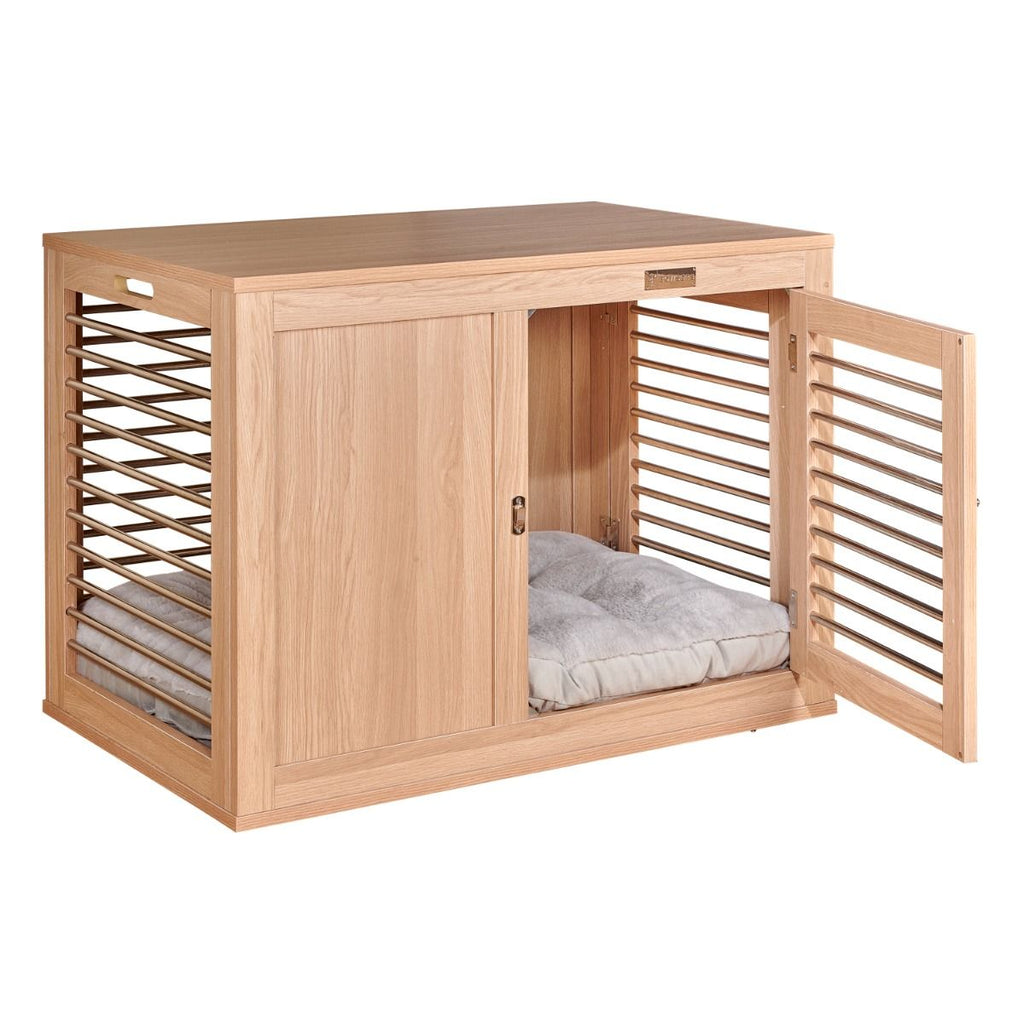 Wooden dog crate with an open slatted door and a light-colored futon bed inside