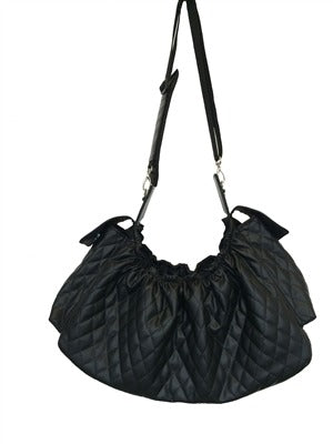 Black quilted sling dog carrier bag with shiny patent trim and adjustable shoulder straps