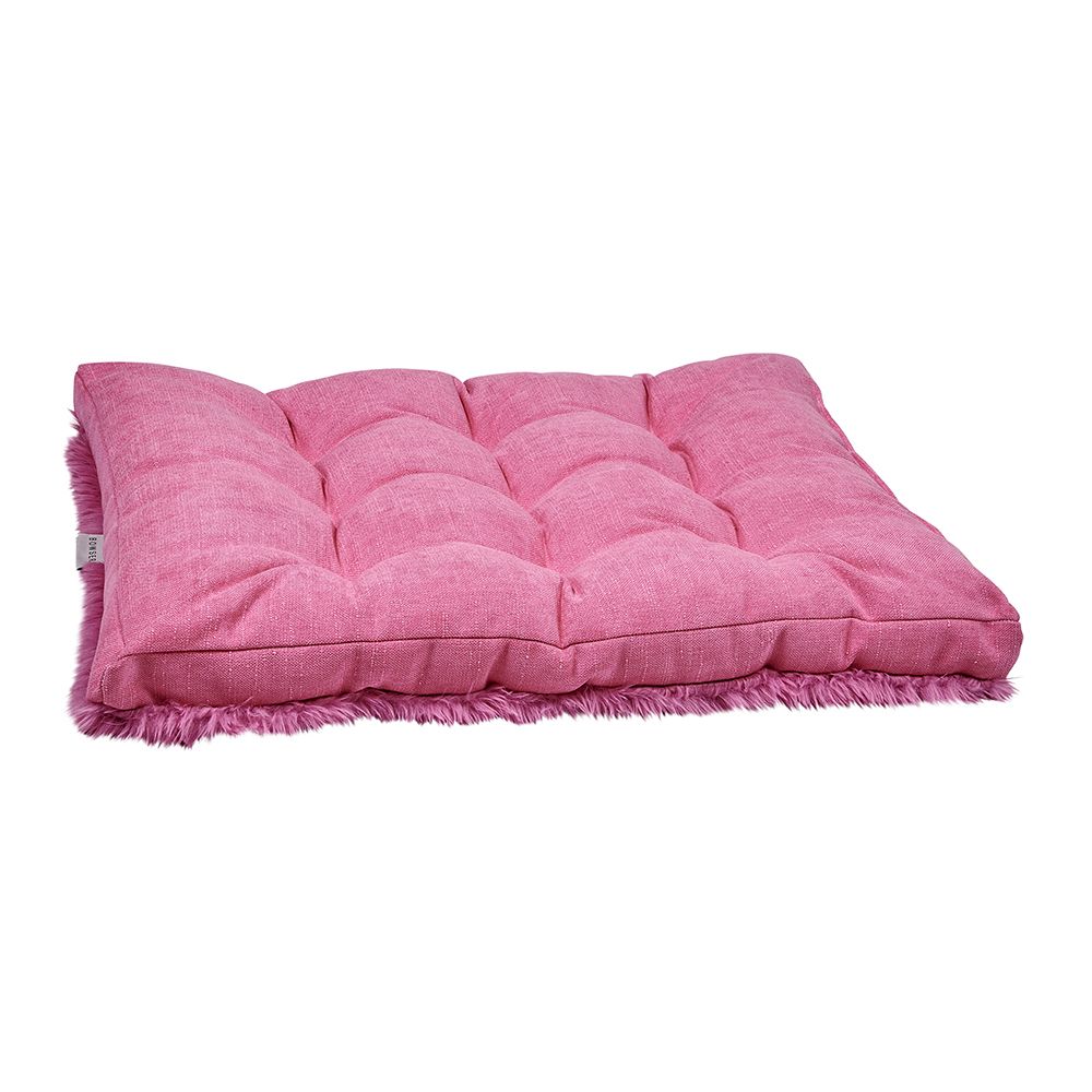 Pink futon dog bed with a quilted cushion and shaggy fringe