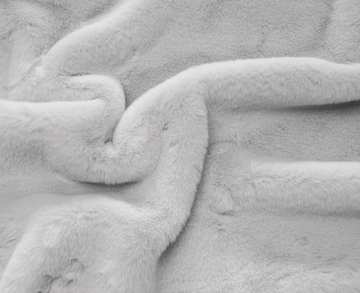 Close-up of the dog bed's soft, light-colored plush fabric