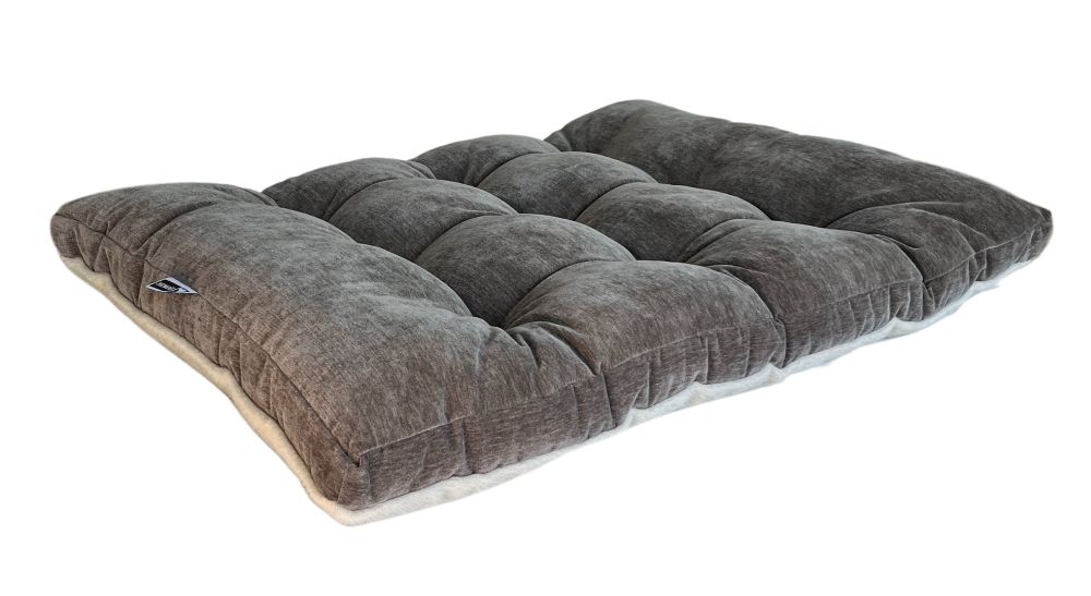 Futon dog bed with a charcoal gray tufted cushion and pale bottom edge