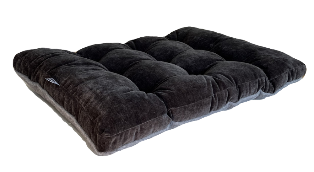 Otter dog bed in dark fabric, with thick tufted cushioning.