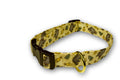 Bear lodge dog collar with yellow patterned fabric, brown buckle, and metal D-ring.
