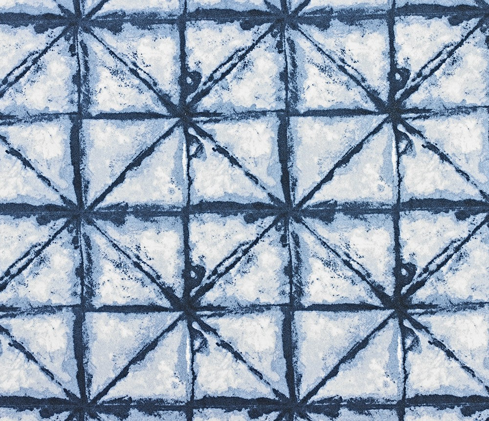 Shibori microvelvet fabric close-up, blue tie-dye starburst pattern with stitched lines